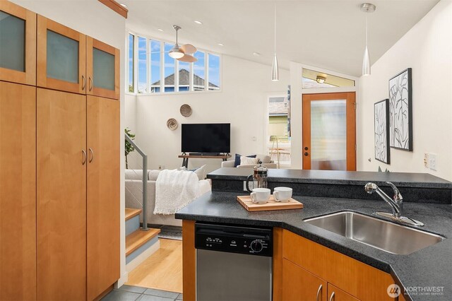 2420 Westlake Ave N Unit 11, Seattle, WA 98109 - kitchen with dishwasher, a sink, dark countertops, glass insert cabinets, and open floor plan