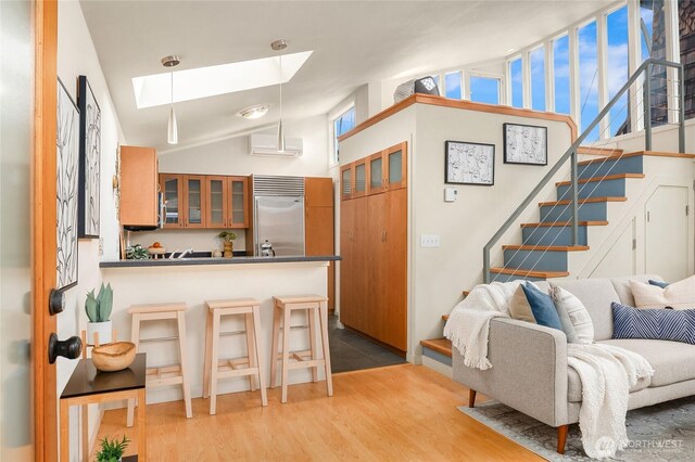 2420 Westlake Ave N Unit 11, Seattle, WA 98109 - living area with a skylight, light wood-style floors, stairway, and high vaulted ceiling