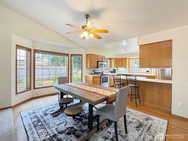 42 Charles Way, Sequim, WA 98382 - dining room with lofted ceiling, ceiling fan, light wood-style floors, and baseboards