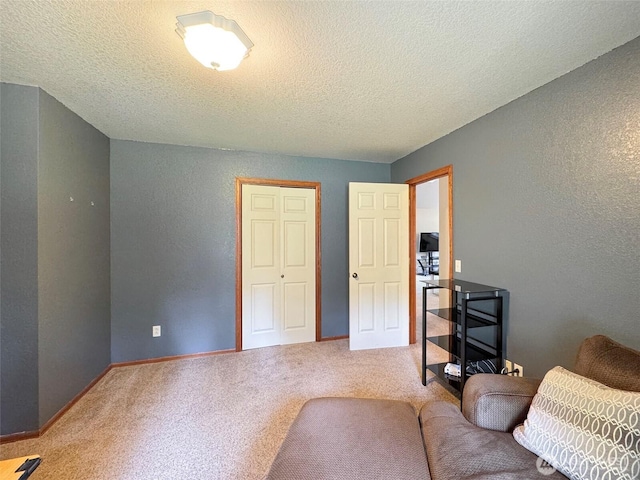 42 Charles Way, Sequim, WA 98382 - living area with carpet, a textured wall, a textured ceiling, and baseboards