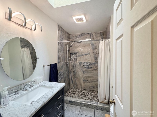 42 Charles Way, Sequim, WA 98382 - full bath featuring vanity, tiled shower, a skylight, and tile patterned floors