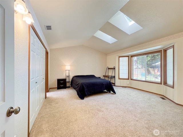 42 Charles Way, Sequim, WA 98382 - bedroom with a skylight, vaulted ceiling, carpet floors, a closet, and baseboards