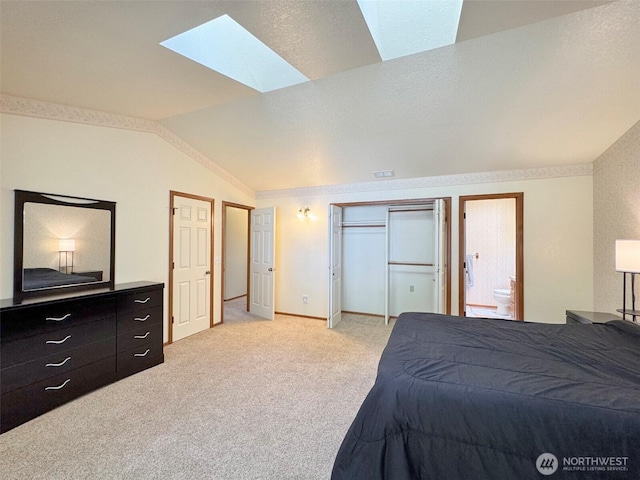 42 Charles Way, Sequim, WA 98382 - bedroom with vaulted ceiling, a skylight, light carpet, baseboards, and connected bathroom