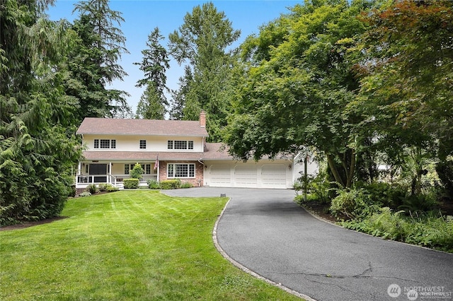 12925 206th Ave NE, Woodinville, WA 98077 - view of front of property featuring driveway, a garage, a chimney, a front lawn, and a porch