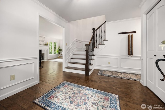 12925 206th Ave NE, Woodinville, WA 98077 - foyer entrance with a decorative wall, hardwood / wood-style flooring, stairs, crown molding, and wainscoting