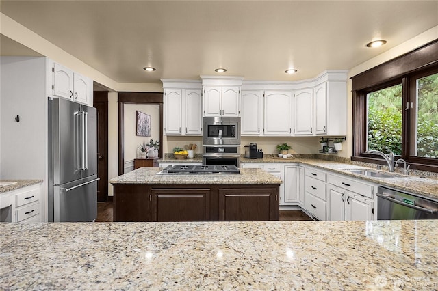 12925 206th Ave NE, Woodinville, WA 98077 - kitchen featuring appliances with stainless steel finishes, a sink, white cabinetry, light stone counters, and recessed lighting