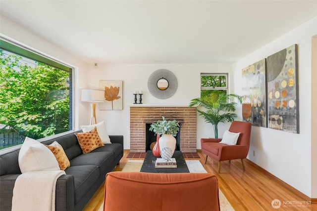 7008 25th Ave NE, Seattle, WA 98115 - living area featuring light wood-style floors and a brick fireplace