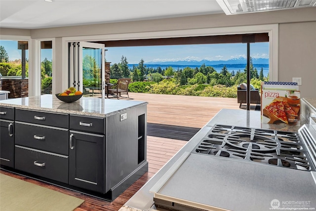 926 Olympic Ave, Edmonds, WA 98020 - kitchen featuring dark cabinetry, dark wood finished floors, a mountain view, light stone counters, and a kitchen island