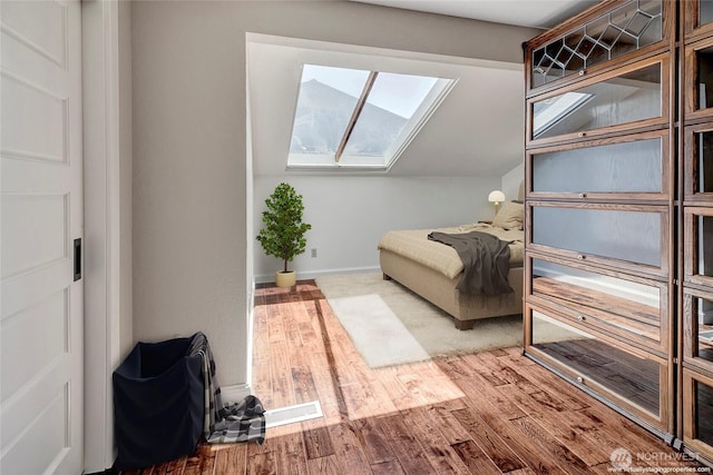 926 Olympic Ave, Edmonds, WA 98020 - bedroom featuring a skylight, wood finished floors, and vaulted ceiling