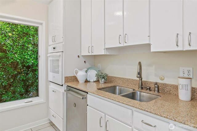101 NW 58th St Unit 9, Seattle, WA 98107 - kitchen featuring a sink, oven, dishwasher, white cabinetry, and light stone countertops
