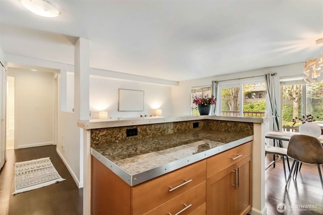 3661 Phinney Ave N Unit 208, Seattle, WA 98103 - kitchen with brown cabinets, dark wood-style flooring, baseboards, and tile countertops