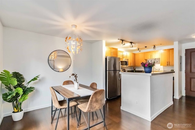 3661 Phinney Ave N Unit 208, Seattle, WA 98103 - dining area with a chandelier, dark wood finished floors, and baseboards