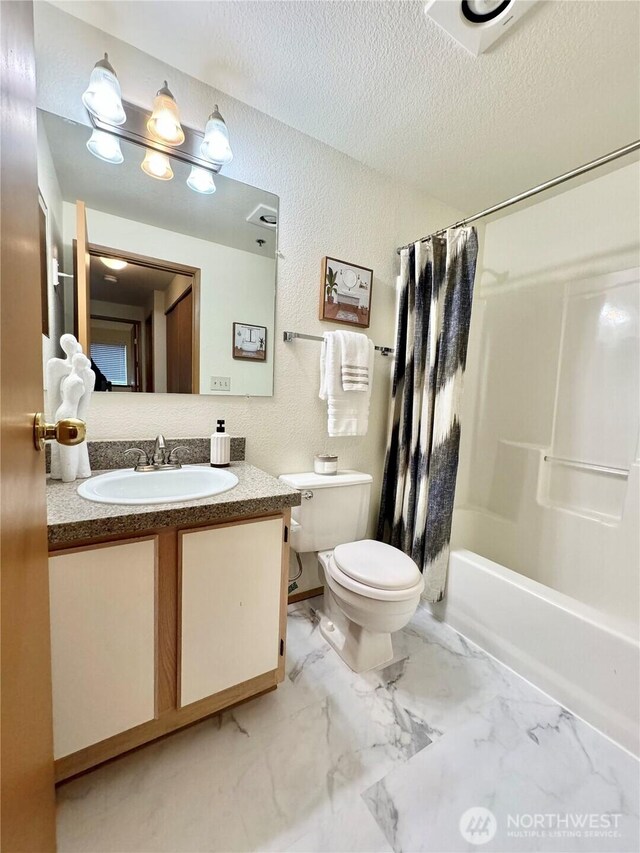 28606 16th Ave S Unit 102, Federal Way, WA 98003 - bathroom featuring toilet, vanity, a textured ceiling, shower / bathtub combination with curtain, and marble finish floors