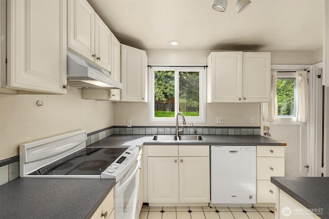 6522 42nd Ave NE, Seattle, WA 98115 - kitchen featuring white appliances, a sink, under cabinet range hood, dark countertops, and white cabinetry