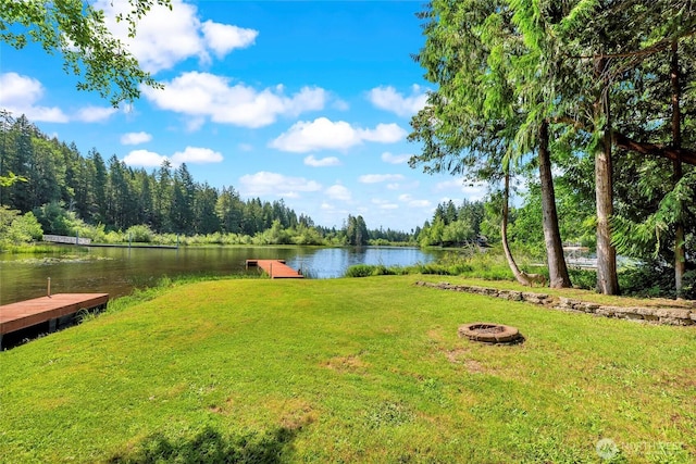 5810 E Mason Lake Dr W, Grapeview, WA 98546 - view of grassy yard with a boat dock, a water view, and an outdoor fire pit