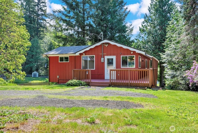 5810 E Mason Lake Dr W, Grapeview, WA 98546 - view of front of home with a front lawn, a deck, and board and batten siding