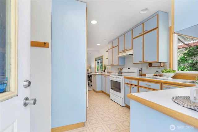 5810 E Mason Lake Dr W, Grapeview, WA 98546 - kitchen featuring white electric range, plenty of natural light, light countertops, under cabinet range hood, and recessed lighting