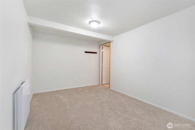 5810 E Mason Lake Dr W, Grapeview, WA 98546 - carpeted empty room featuring radiator, baseboards, and a textured ceiling