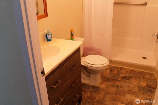 153 NW Quincy Pl, Soap Lake, WA 98851 - bathroom with vanity, a stall shower, stone finish flooring, and toilet