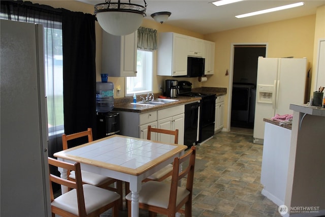 153 NW Quincy Pl, Soap Lake, WA 98851 - kitchen with black appliances, stone finish flooring, a sink, white cabinetry, and vaulted ceiling