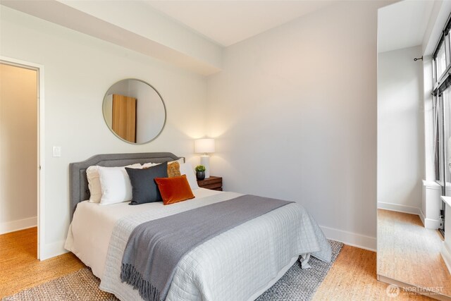 615 E Pike St Unit 306, Seattle, WA 98122 - bedroom with baseboards and light wood-style flooring