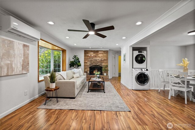 1315 SW 310th St, Federal Way, WA 98023 - living area with stacked washer / dryer, a wall unit AC, ceiling fan, wood finished floors, and baseboards