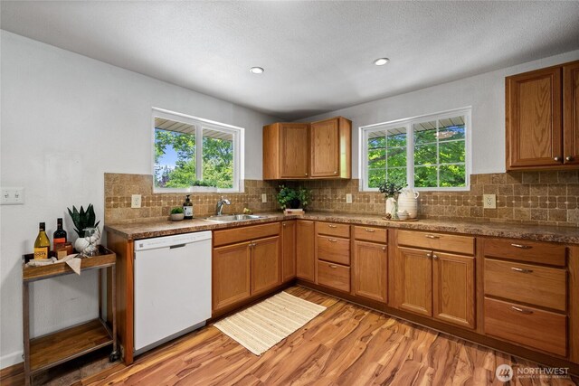 1315 SW 310th St, Federal Way, WA 98023 - kitchen with white dishwasher, a sink, light wood-style floors, plenty of natural light, and recessed lighting