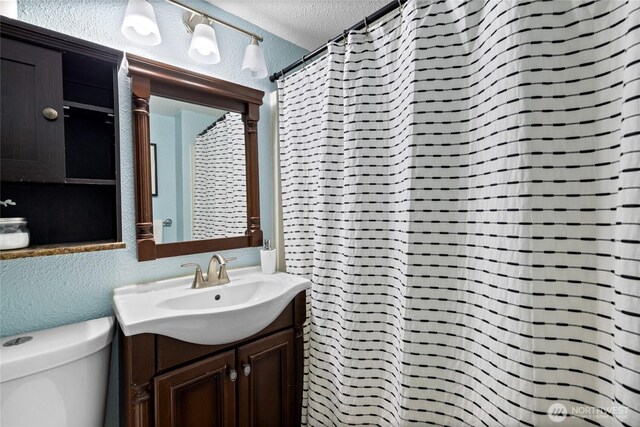 1315 SW 310th St, Federal Way, WA 98023 - full bathroom featuring a textured ceiling, vanity, a textured wall, toilet, and a shower with curtain