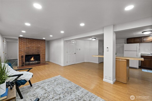 1315 SW 310th St, Federal Way, WA 98023 - living room with light wood-style flooring, a fireplace, recessed lighting, and baseboards