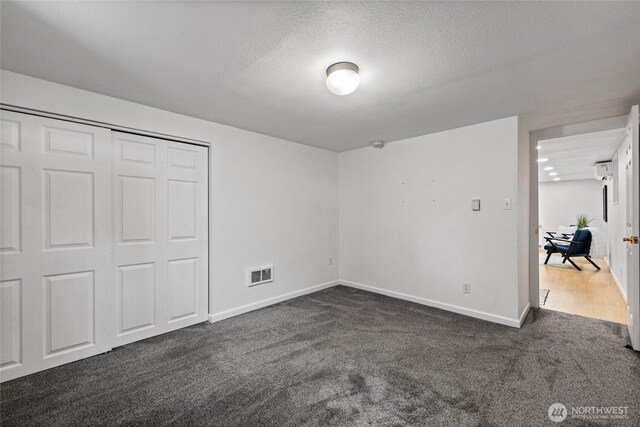 1315 SW 310th St, Federal Way, WA 98023 - unfurnished bedroom featuring dark carpet, a textured ceiling, baseboards, and a closet