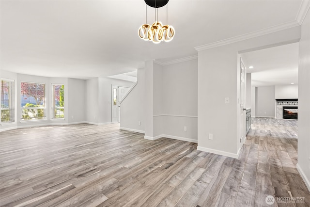 35426 8th Ave SW, Federal Way, WA 98023 - unfurnished room with light wood-style flooring, a chandelier, crown molding, and a tiled fireplace