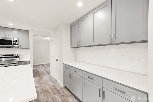 35426 8th Ave SW, Federal Way, WA 98023 - kitchen with stainless steel appliances, gray cabinets, decorative backsplash, recessed lighting, and light wood-type flooring