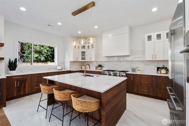 1002 N 31st St, Renton, WA 98056 - kitchen with a sink, white cabinetry, a center island with sink, glass insert cabinets, and recessed lighting