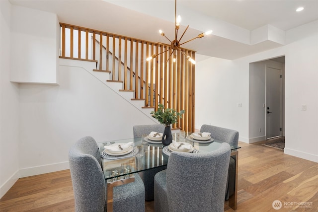 1002 N 31st St, Renton, WA 98056 - dining room with a chandelier, baseboards, wood finished floors, stairway, and recessed lighting
