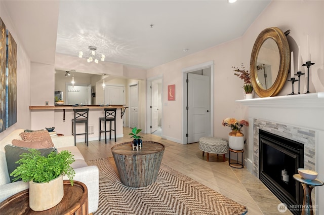 1545 NW 57th St Unit 220, Seattle, WA 98107 - living area with a tiled fireplace, baseboards, a chandelier, and recessed lighting