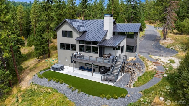 1450 Creekside Rd, Cle Elum, WA 98922 - rear view of house featuring stairs, a standing seam roof, a patio area, a deck, and a chimney