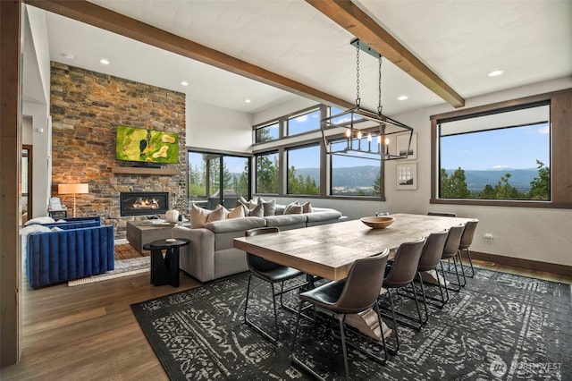 1450 Creekside Rd, Cle Elum, WA 98922 - dining area with beamed ceiling, wood finished floors, a stone fireplace, recessed lighting, and baseboards