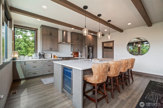 1450 Creekside Rd, Cle Elum, WA 98922 - kitchen featuring wall chimney exhaust hood, wine cooler, a sink, beamed ceiling, and wood finished floors
