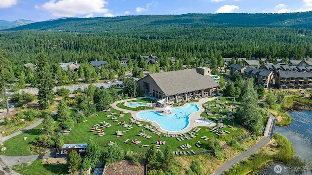 3770 Suncadia Trl Unit 110, Cle Elum, WA 98922 - aerial overview of property's location featuring a heavily wooded area, a pool, and a mountainous background