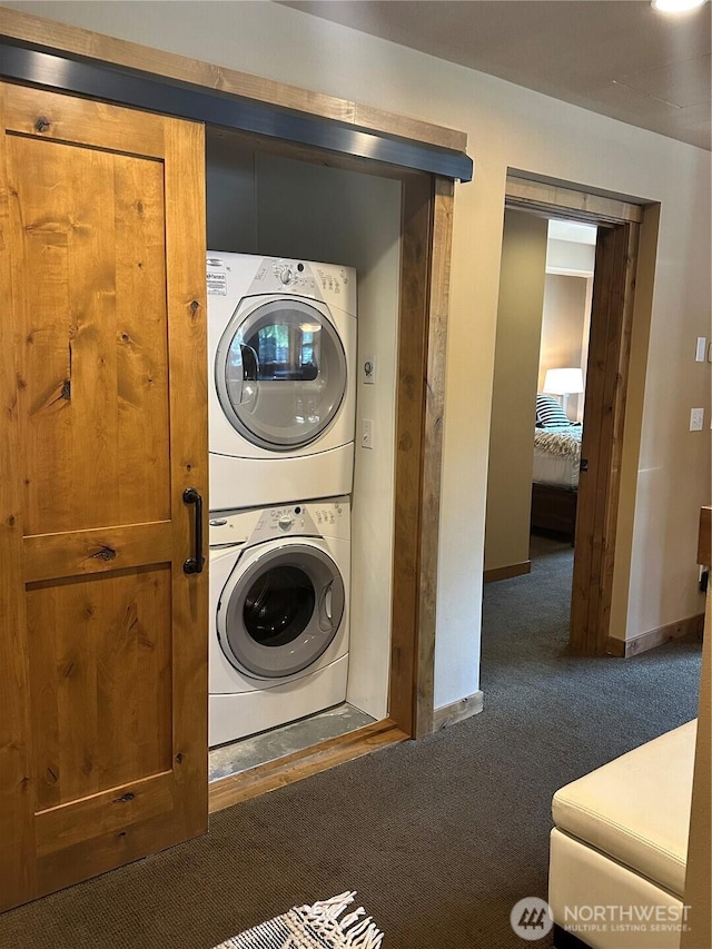 3770 Suncadia Trl Unit 110, Cle Elum, WA 98922 - washroom featuring stacked washer and clothes dryer, carpet, and baseboards