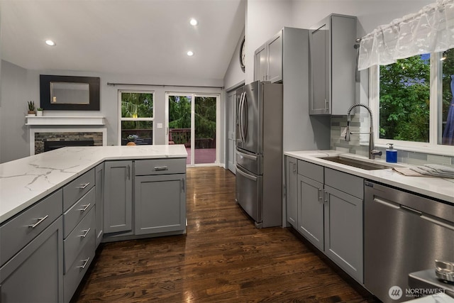 14566 86th Pl NE, Kenmore, WA 98028 - kitchen with stainless steel appliances, gray cabinetry, a sink, light stone countertops, and vaulted ceiling