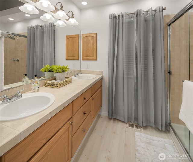 14566 86th Pl NE, Kenmore, WA 98028 - full bath featuring a shower stall, wood finished floors, and double vanity