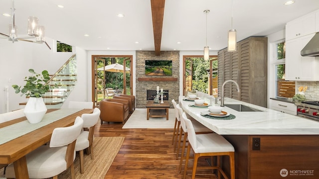 5619 89th Ave SE, Mercer Island, WA 98040 - dining room with a stone fireplace, dark wood-style flooring, healthy amount of natural light, recessed lighting, and beamed ceiling
