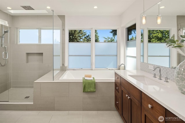 5619 89th Ave SE, Mercer Island, WA 98040 - bathroom featuring vanity, a shower stall, a bath, recessed lighting, and backsplash