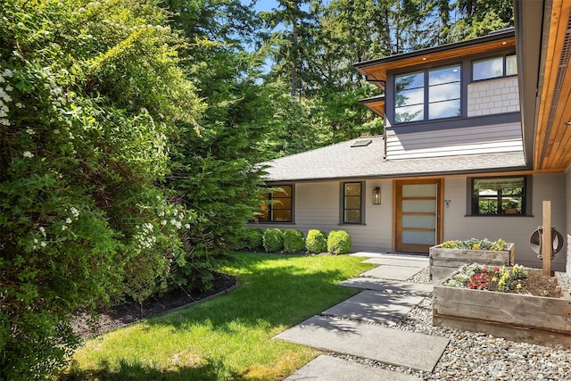 5619 89th Ave SE, Mercer Island, WA 98040 - view of front of house featuring a front yard, a shingled roof, and a vegetable garden