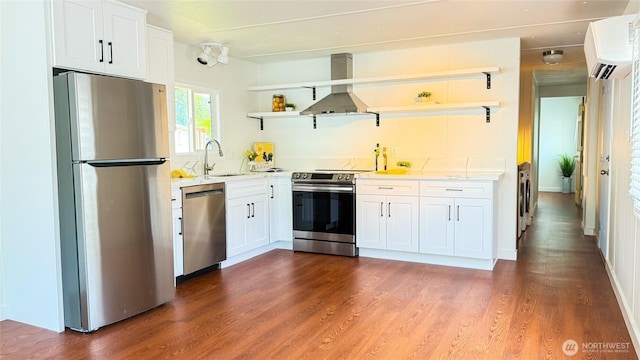 42010 SE N Bend Way Unit 29, North Bend, WA 98045 - kitchen featuring appliances with stainless steel finishes, open shelves, a sink, washing machine and clothes dryer, and an AC wall unit