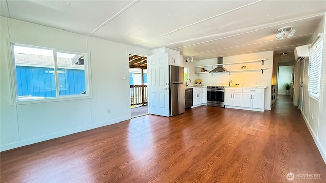 42010 SE N Bend Way Unit 29, North Bend, WA 98045 - unfurnished living room with dark wood finished floors, a sink, baseboards, and a wall unit AC