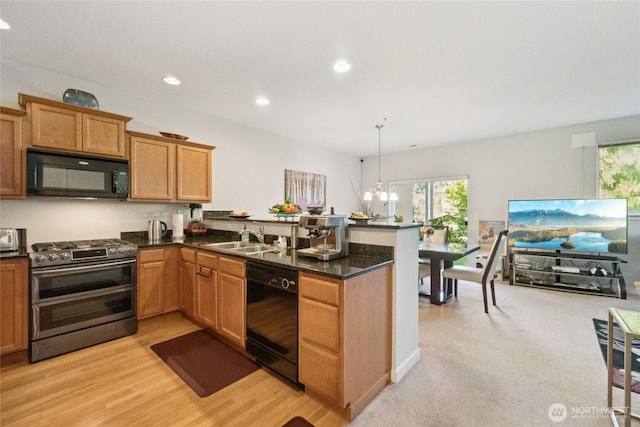 4118 148th St SW Unit A4, Lynnwood, WA 98087 - kitchen featuring black appliances, a sink, a peninsula, plenty of natural light, and recessed lighting