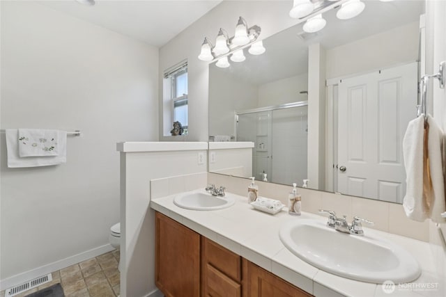 4118 148th St SW Unit A4, Lynnwood, WA 98087 - bathroom with a stall shower, toilet, baseboards, and double vanity