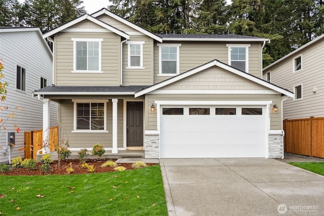 20320 150th St E, Bonney Lake, WA 98391 - view of front of property with driveway, stone siding, and covered porch